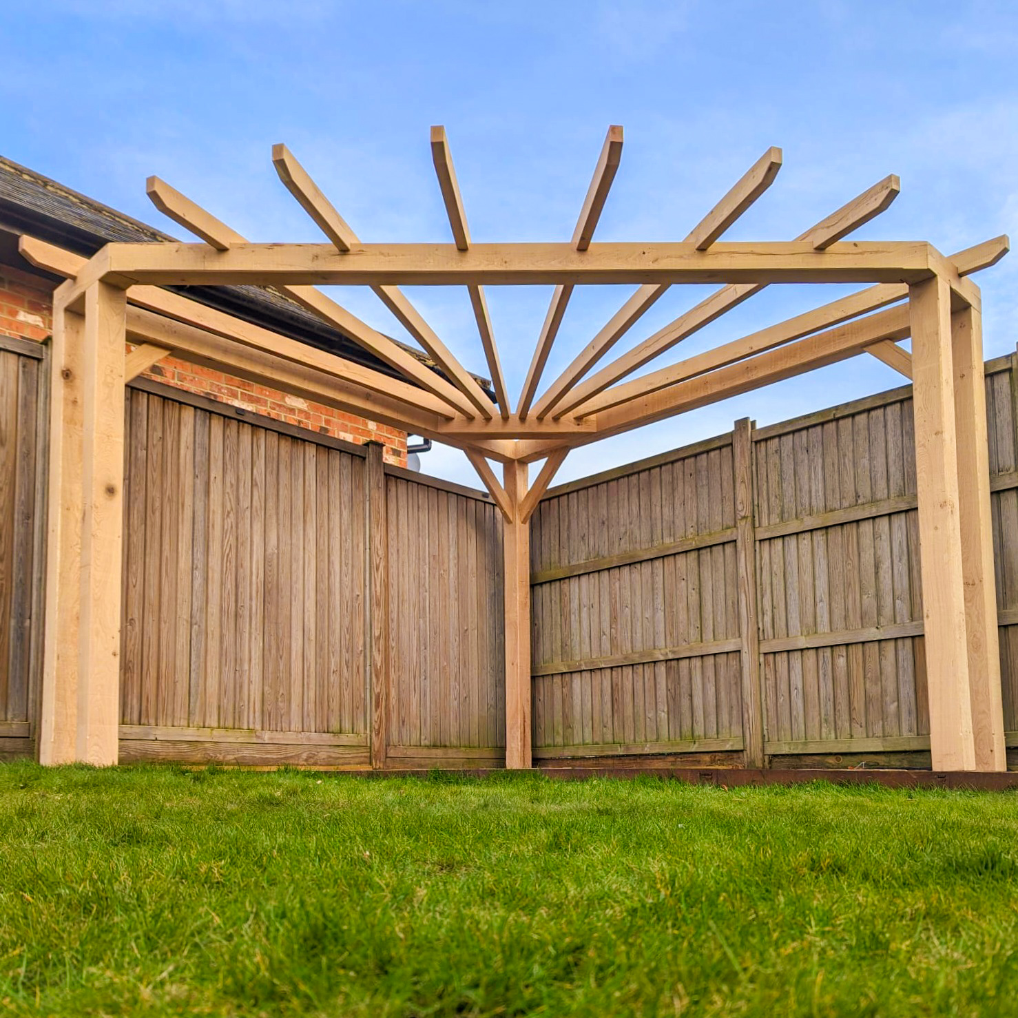 Oak pergola corner and posts with calm, architectural lines.