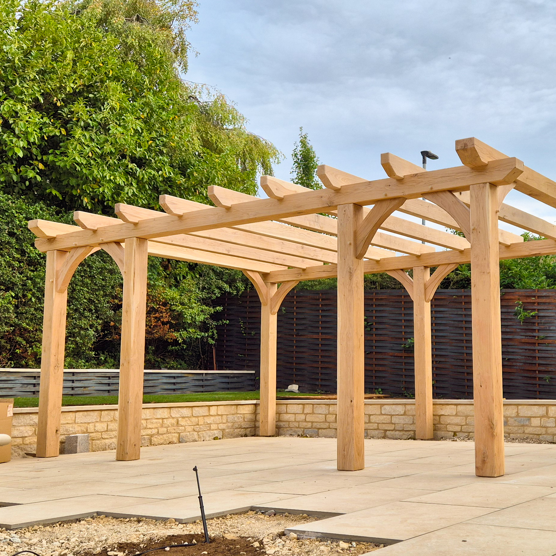 Contemporary oak pergola in a landscaped garden near Stamford.